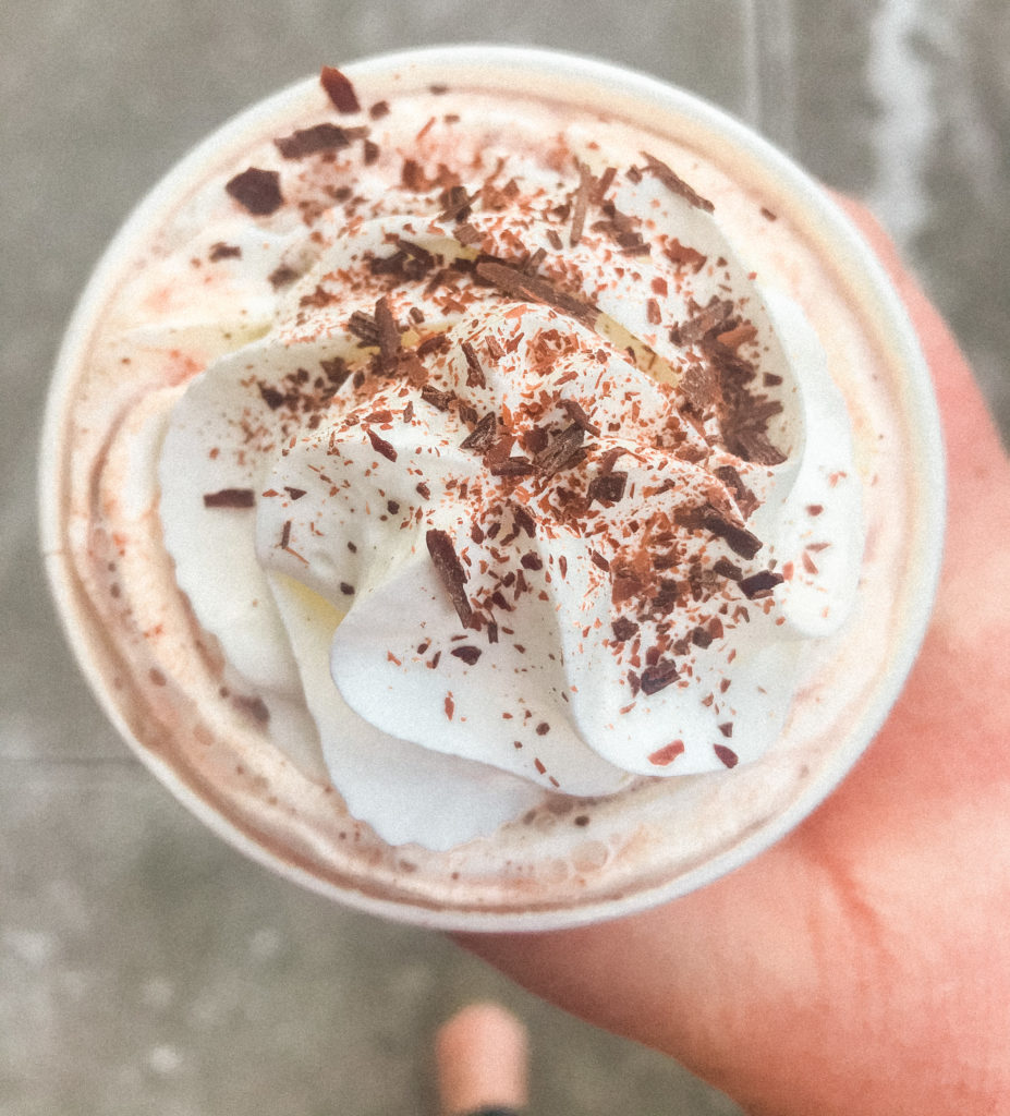 A rich cup of cocoa from Maverick Chocolate Co., topped with whipped cream and milk chocolate shavings